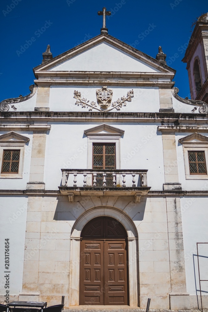 Old Portuguese street. Classic architecture and church from Portugal. Vintage cultural style.