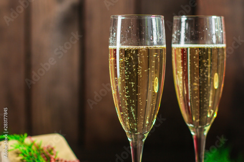 champagne in transparent glasses and a bottle (New Year's atmosphere, Christmas) of happy holidays! top food background. copy space