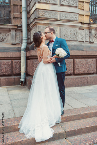 Happy bride and groom tenderly kissing on wedding day. © Artem
