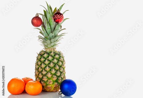 Pineapple, tangerines, Christmas toy on a white background