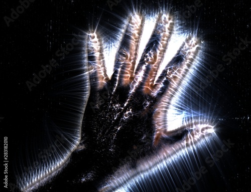 Kirlian aura photography of a glowing human female hand showing different symbols and show of hands photo