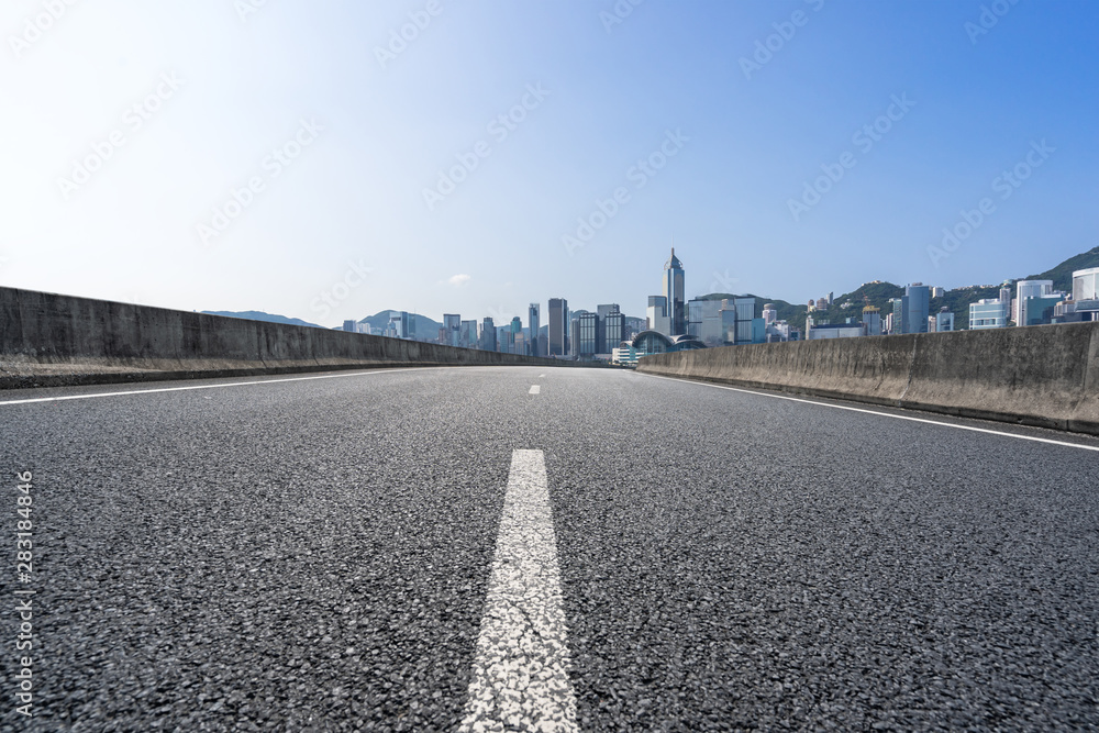 Fototapeta premium empty road with city skyline