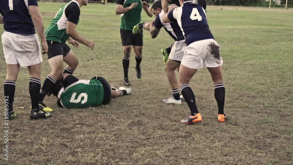 Rugby players striving for ball at sports arena. Rugby players in action during a league match. Rugby players striving for ball at sports arena. Rugby players in action during a league match.