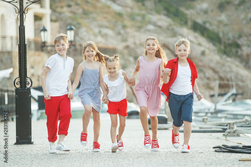 Fototapeta Naklejka Na Ścianę i Meble -  Fashionable children by the sea. Children's fashion. 