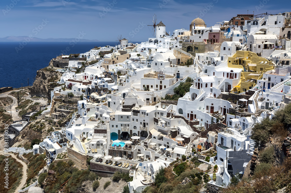 Panoramic view from Oia village with windmill on Santorini island, Greece.