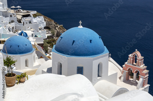 Greece. Cyclades Islands - Santorini (Thira). Oia town with typical Cycladic architecture - painted blue cupolas and white walls of houses. The Anastasis Church.