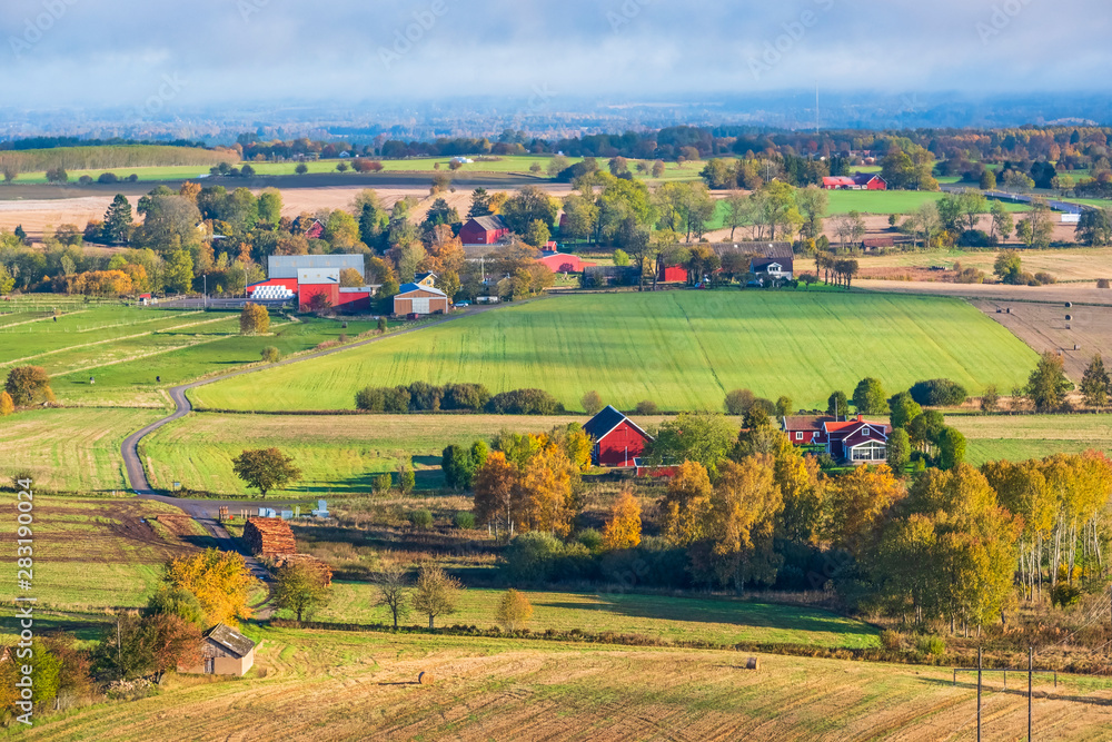 Aerial view at a the countryside with farms and fields in autumn