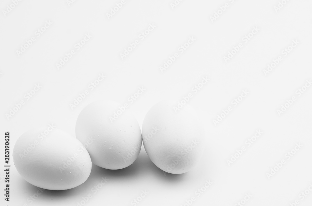 white eggs on a white background - natural shapes backdrop