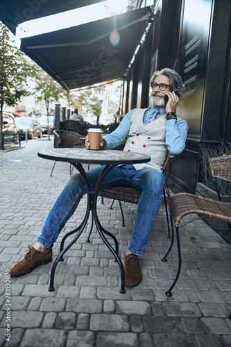 Relaxed man enjoying phone talk stock photo