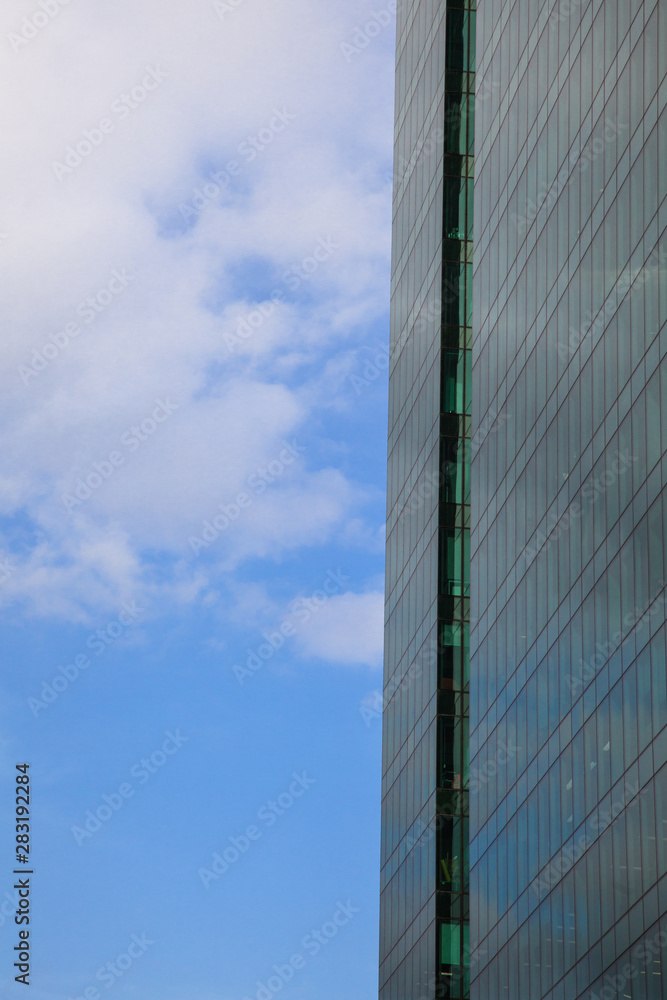 part of the facade of a glass skyscraper against the blue sky with the reflection of sunlight part of the facade of a glass skyscraper against the blue sky with the reflection of sunlight