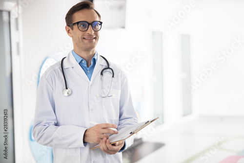 Cheerful male physician working in clinic stock photo