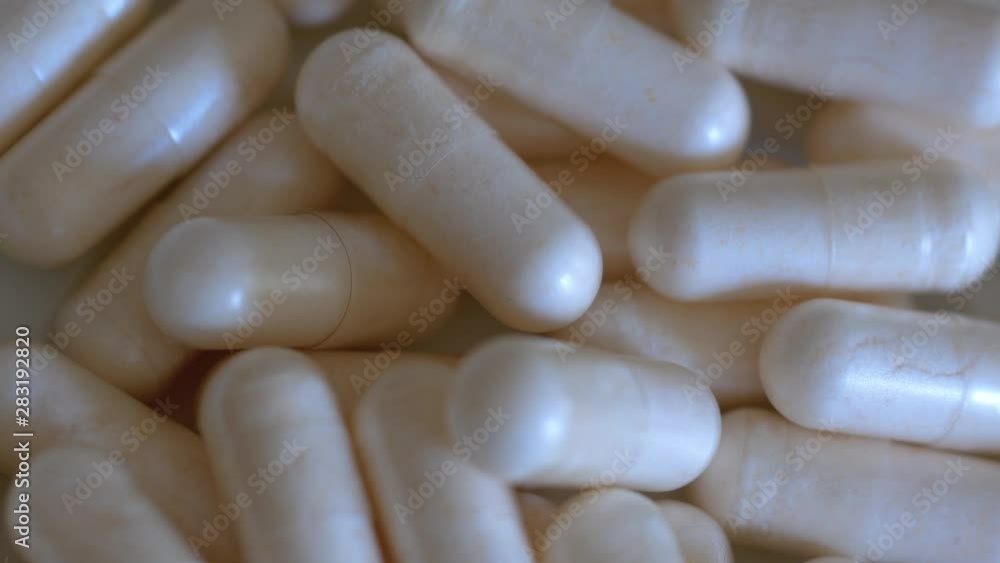 Macro Close-up of A Rotating Heap of Capsules, Pharmacy Background With Selected Focus Macro Close-up of A Rotating Heap of Capsules, Pharmacy Background With Selected Focus