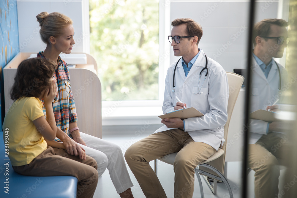 Therapist is consulting child with mother stock photo Therapist is consulting child with mother stock photo