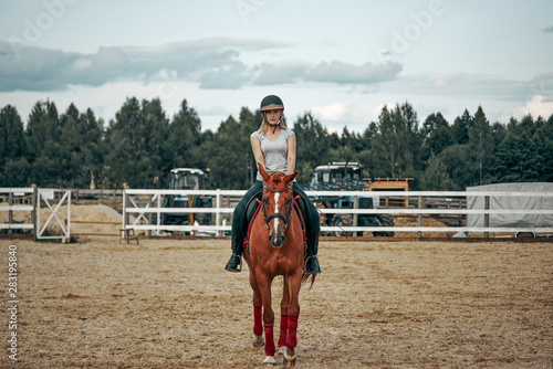 girl rider riding a horse on a ranch. Horseback Riding.