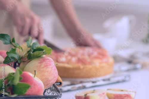 Woman's hand serving a slice of a freshly baked cake she just made at home. Tasty breakfast.
