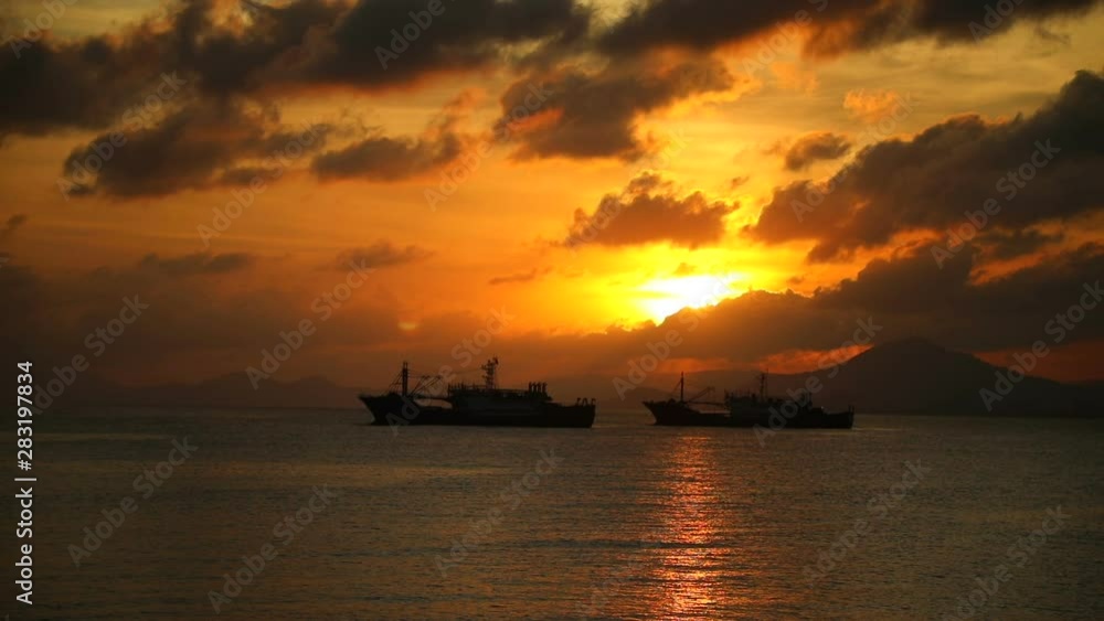 Fishing boats on sea in sunset lights in Sanya, Hainan, China Fishing boats on sea in sunset lights in Sanya, Hainan, China