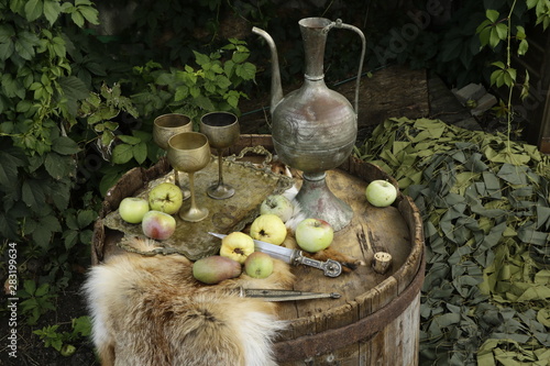 still life on a barrel, with apples, a jug and a dagger. 