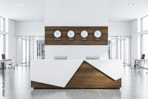 White and wood reception desk in office