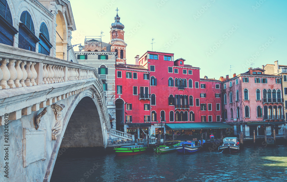 Naklejka premium View of the canal with boats and gondolas in Venice, Italy. Venice is a popular tourist destination of Europe.
