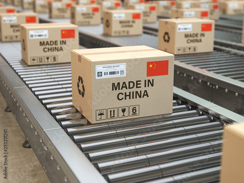 Made in China. Cardboard boxes with text made in China and chinese flag on the roller conveyor.