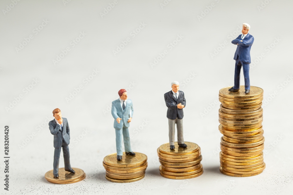 Successful businessman with big profits at the top of the stairs by coins and less successful businessmen with small companies. Adequate investment in the company. Successful businessman with big profits at the top of the stairs by coins and less successful businessmen with small companies. Adequate investment in the company.