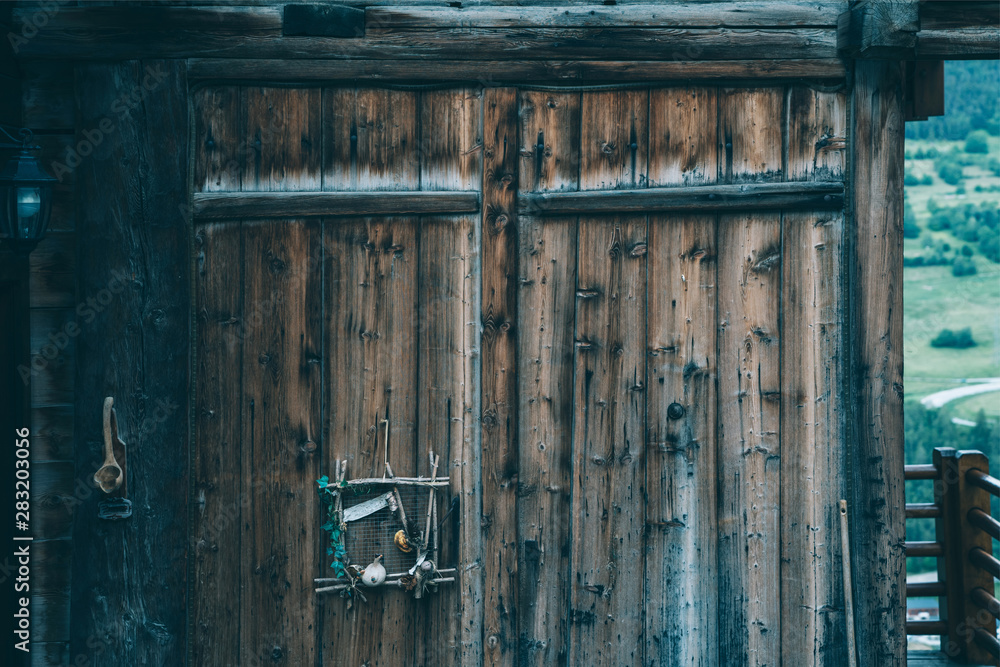The wall of old wooden house in traditional swiss alpine village. Rural mountain chalet. The wall of old wooden house in traditional swiss alpine village. Rural mountain chalet.