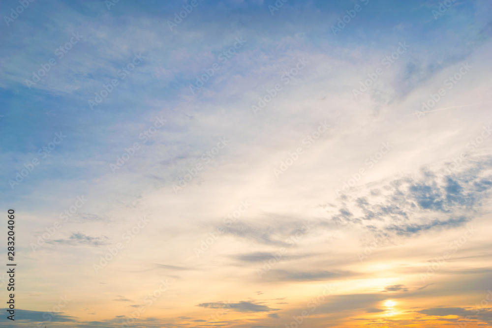 Obraz premium Sky blue and orange light of the sun through the clouds in the sky