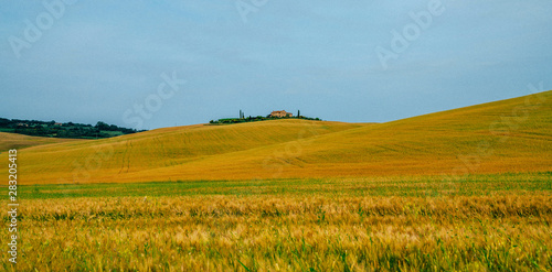 Beautiful landscape with farmhouse, one of the most famous places in Tuscany, Italy. Europe tourism or holiday vacation travel concept. Vintage tone filter effect with noise and grain.