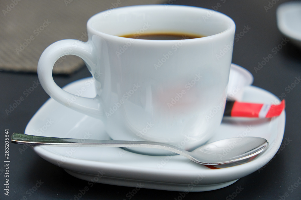 white espresso cup on a saucer with coffee spoon white espresso cup on a saucer with coffee spoon