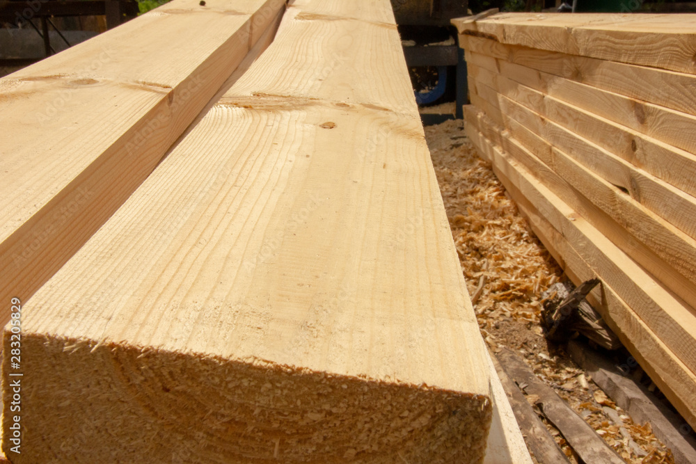 processed boards at a sawmill. Smooth, turned, polished boards at a wood processing plant. processed boards at a sawmill. Smooth, turned, polished boards at a wood processing plant.