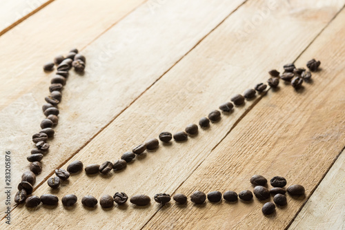 diagram chart trend from coffee beans on wooden background. business concept. business still life.