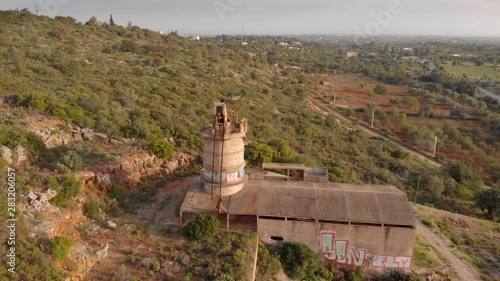 Derelict quicklime factory building in Portugal, panning right, high angle photo