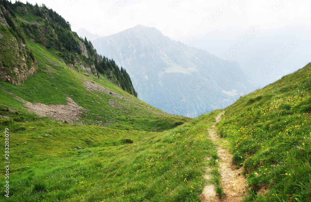 Naklejka premium Alpine peaks landskape. Lauterbrunnen, Jungfrau, Bernese highland. Alps, tourism, journey, hiking