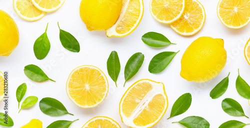 Fresh lemon and slices with leaves isolated on white