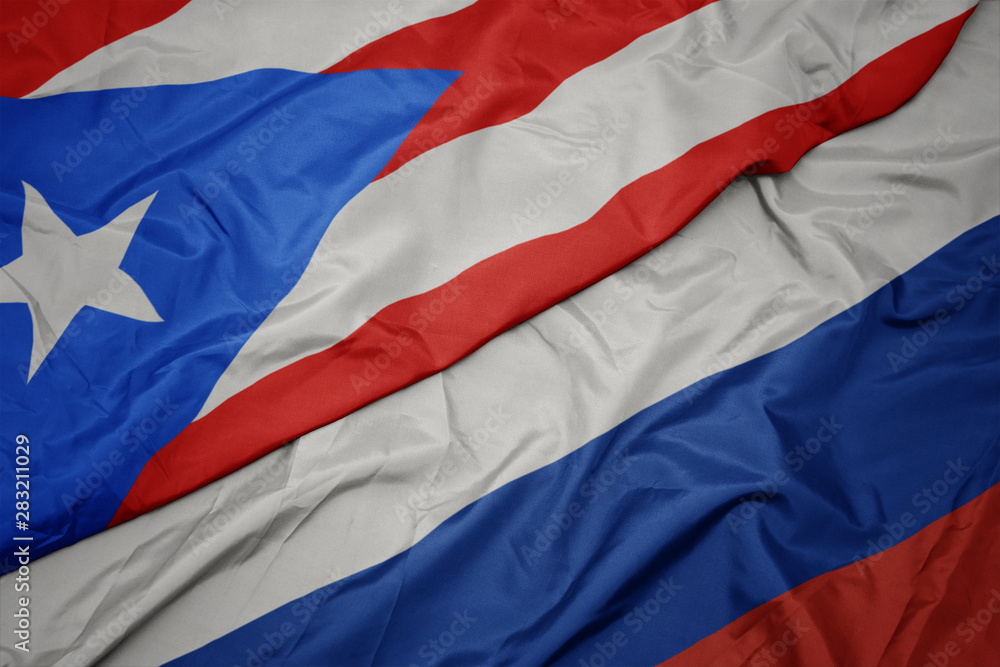 waving colorful flag of russia and national flag of puerto rico. waving colorful flag of russia and national flag of puerto rico.