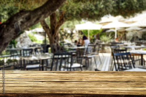 Table background with blurred outside restaurant. Empty space for advertising products and decortation. © magdal3na
