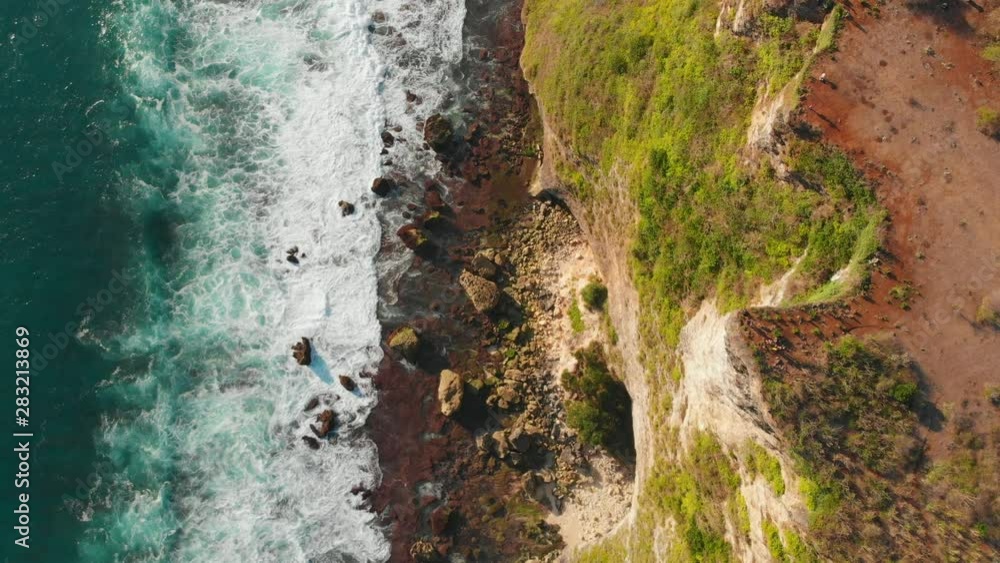 Aerial view of rocky cliff and ocean with waves. No people. Aerial view of rocky cliff and ocean with waves. No people.