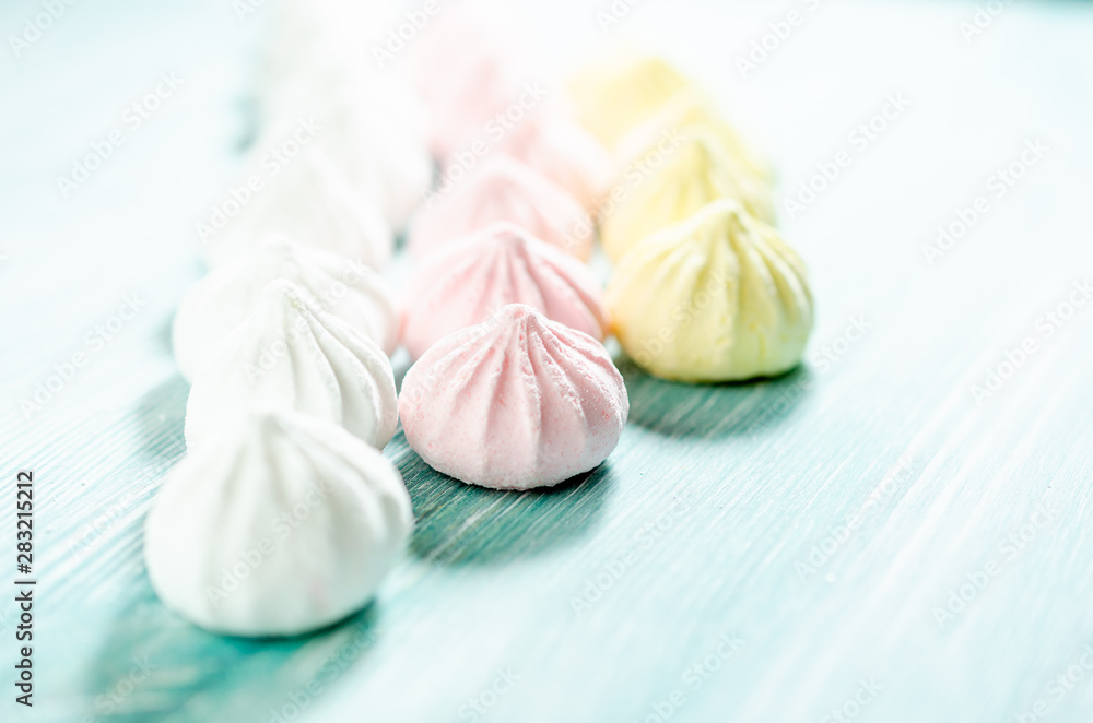 Colored sweet meringues. Dessert background.
