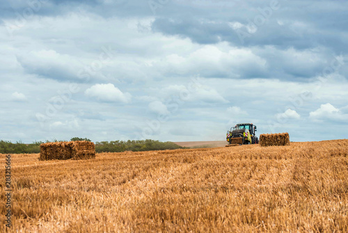 tractor and its trailer to make straw bales