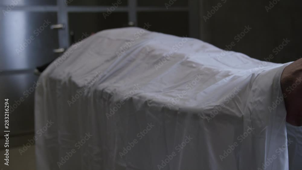 Scene in a modern morgue - body on gurney Scene in a modern morgue - body on gurney