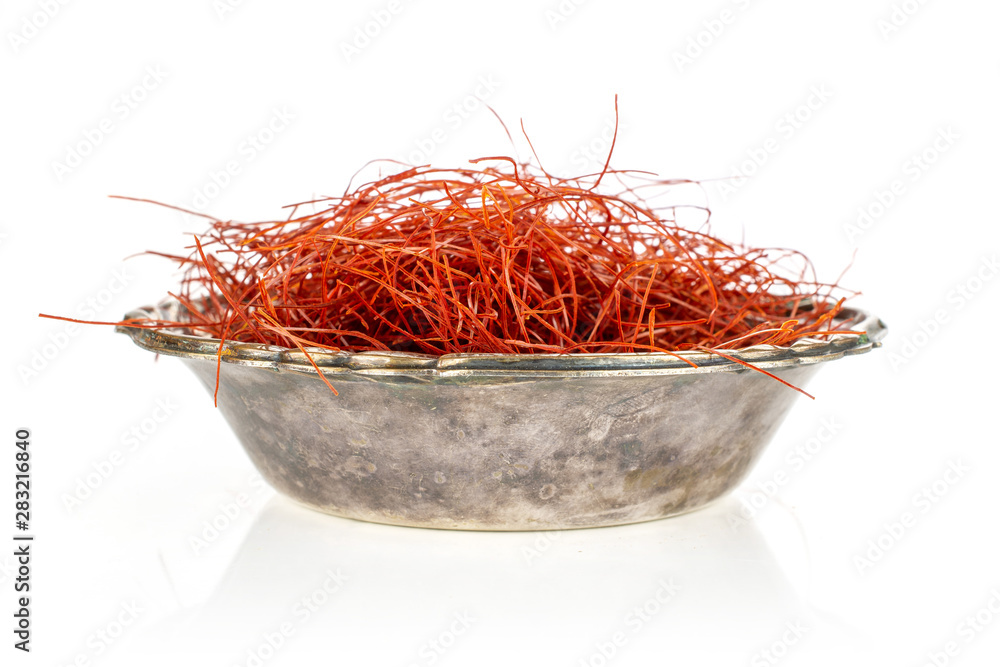 Fototapeta premium Lot of whole red chili pepper threads in old iron bowl isolated on white background