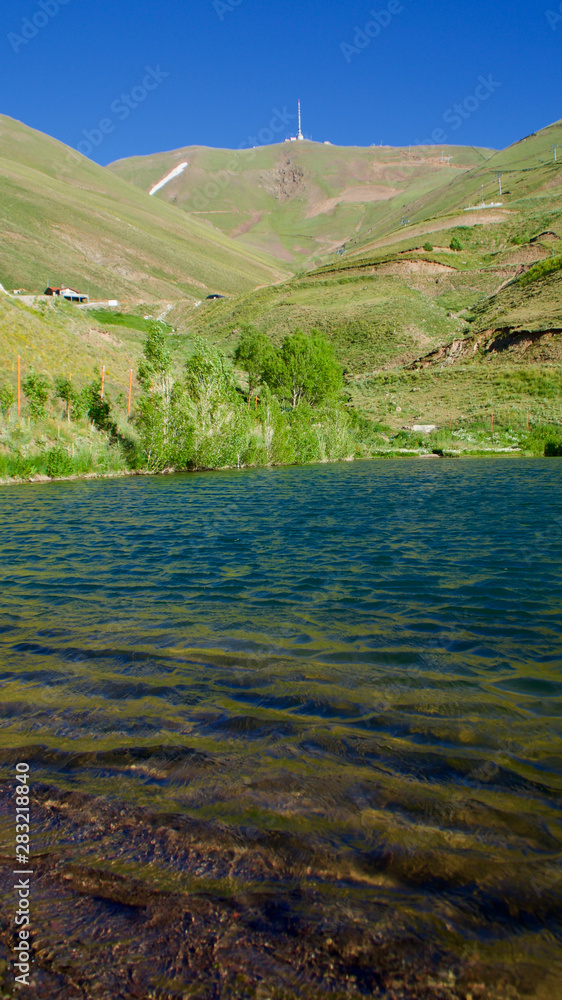 Palandoken mountain, ponds and livestock in the village in Erzurum in summer