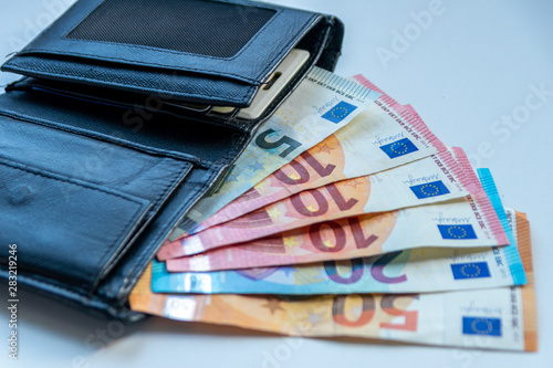 EURO-Geldscheine stecken in einem schwarzen Portemonnaie und stehen für Bargeld, Cash, Reichtum, passives Einkommen und Bezahlung im Finanzsektor photo