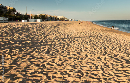 footprints flooded with sea water on the beach sand in the Calella area of Spain