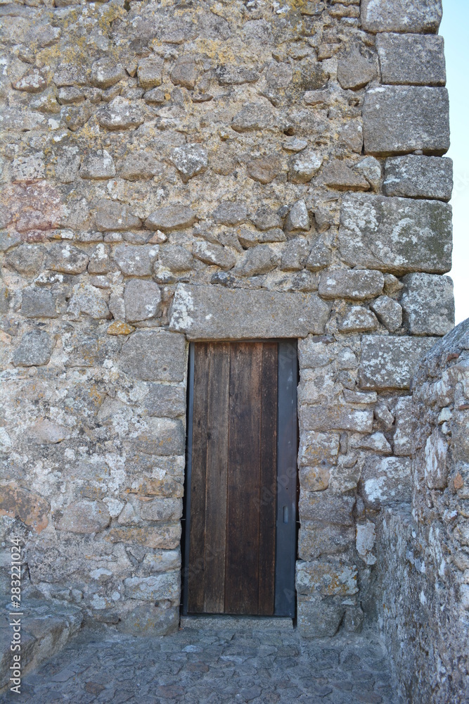 Stone Castle Tower With Wooden Doorway In a Medieval Defense Fortress in Portugal Stone Castle Tower With Wooden Doorway In a Medieval Defense Fortress in Portugal