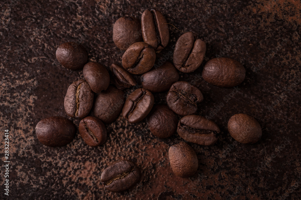 Coffee beans on stone background. Top view with copy space for your text. Roasted coffee beans background. Beans texture, macro Coffee beans on stone background. Top view with copy space for your text. Roasted coffee beans background. Beans texture, macro