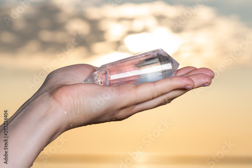 Vogel Style Double Terminated Wand in woman's hand at sunrise in front of the lake.