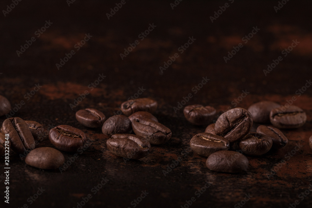 Coffee beans on stone background. Top view with copy space for your text. Roasted coffee beans background. Beans texture, macro Coffee beans on stone background. Top view with copy space for your text. Roasted coffee beans background. Beans texture, macro
