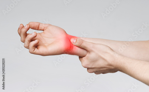 Young man suffering from carpal tunnel syndrome photo