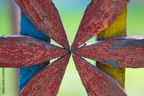 Obraz na plátně Colorful threadbare wooden ornament on fence as background